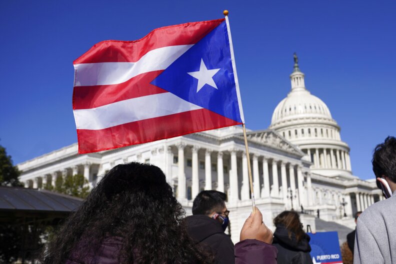 A woman waves the flag of Puerto Rico.