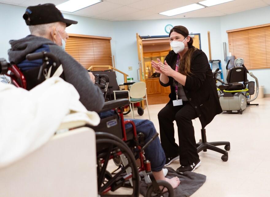 Amanda Eldridge, a certified occupational therapist assistant, works with a veteran resident last week.