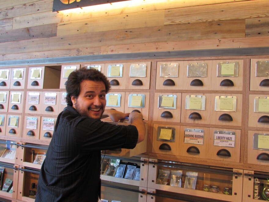 Ben Perez works behind the counter at the new Dockside SODO marijuana retail store.