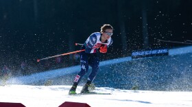 An action shot of a cross-country skier racing through the snow.