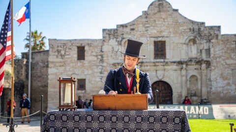 Reenactor Sam Haynie reads aloud from the famous "Travis Letter" written by Alamo Commander William Barret Travis, which called for outside aid to come to the surrounded fortress
