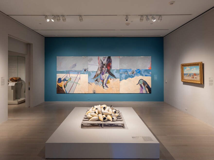 The painting "Possession on the Beach" by Fritz Scholder looms over a glossy pile of whale teeth, called "Beach Logbook 22/Breach #2" by Courtney M. Leonard.