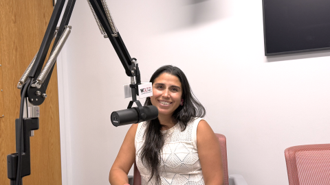 Dr. Javiera Monardez Popelka sitting behind a microphone in the WGLT studios.