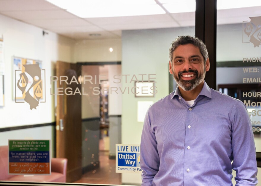 Adrian Barr poses for a photo inside his office