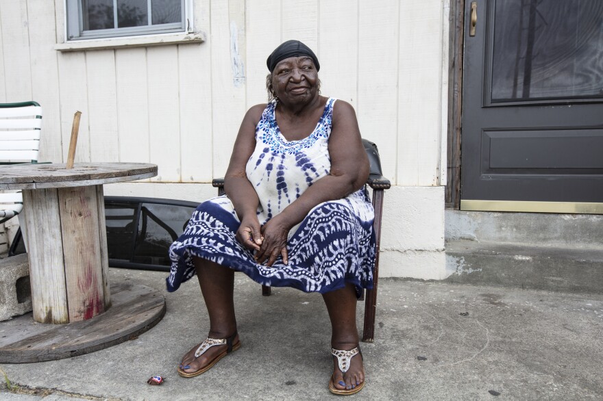 Georgia Ramson, 75, sits in front of her house and talks to neighbors in the Northside neighborhood of Wilmington, N.C. Ramson says she is not worried about the storm because she has seen many hurricanes hit the area in her lifetime.
