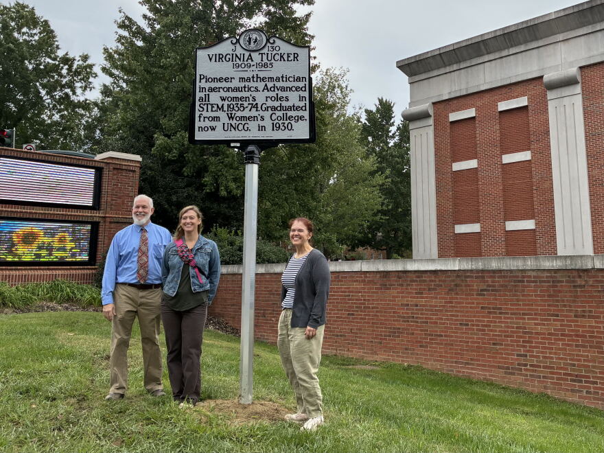Meredith College professor Daniel Fountain (left), Leslie Cruickshank with the NC Highway Historical Marker Program (center) and UNCG University Archivist Erin Lawrimore (right) pose with the new historical marker for Virginia Tucker. 