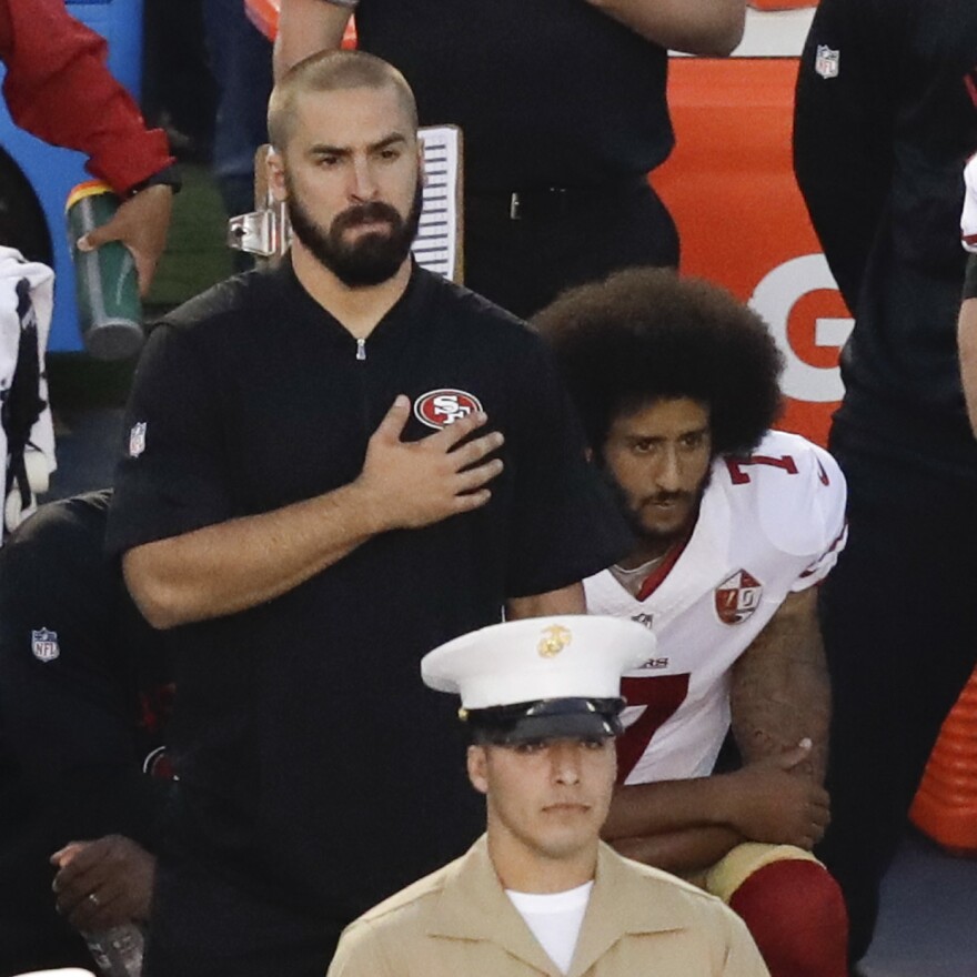 Colin Kaepernick, quarterback of the San Francisco 49ers, kneels during the national anthem before Thursday night's game in San Diego.