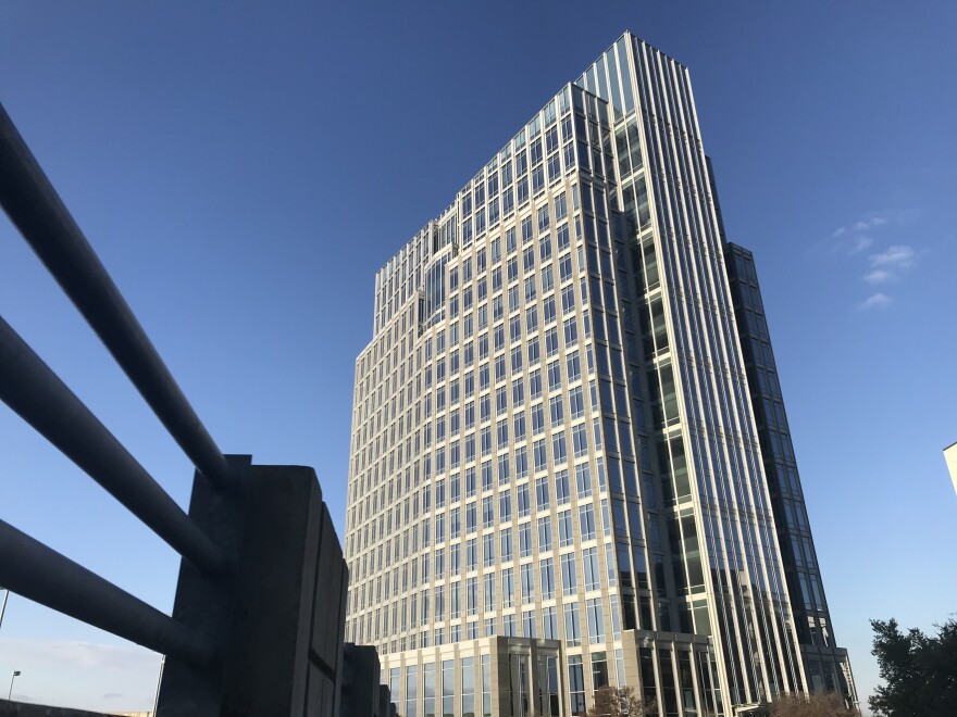 The Pier 1 building towers in front of a blue sky.