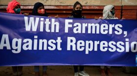 Demonstrators take part in a march organised in support of farmers protesting against the central governments recent agricultural reforms in New Delhi.
