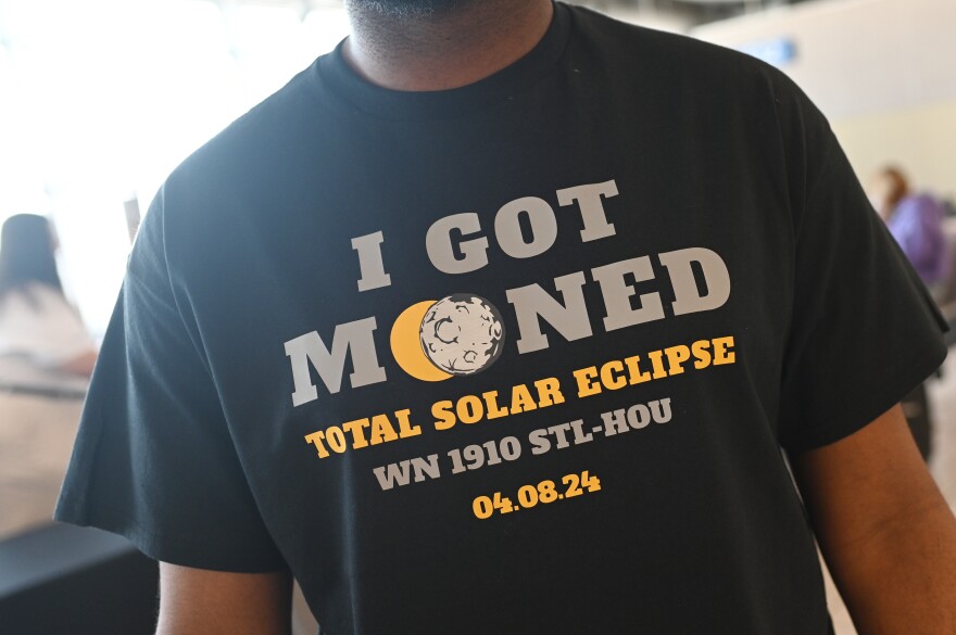 Southwest Airlines gate staff wear commemorative eclipse shirts prior to Southwest Flight 1910 highlighting the total solar eclipse from St. Louis to Houston, Texas on April 8, 2024 at Lambert International Airport in St. Louis, Missouri.