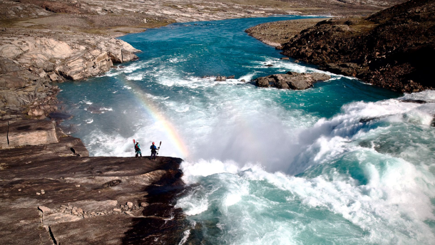 Still of a large waterfall and two rafters standing off to the side from the Banff Centre Mountain Film Festival World Tour