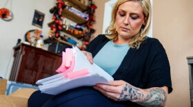 Haley Ness examines paperwork from her time as an Adult Protective Services investigator in Pierce County. She took on complex and high-profile investigations into abuse, neglect, and exploitation of vulnerable adults.