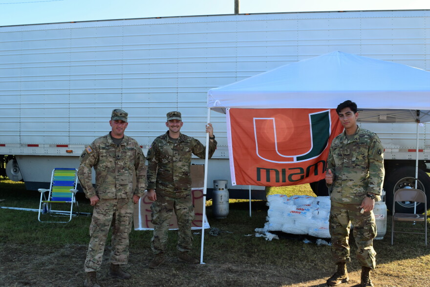 National Guard members at this point of distribution are ready to load ice into the cars of hurricane victims. 