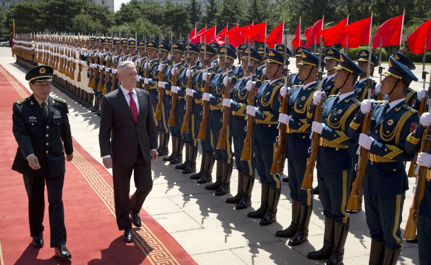 China's Defense Minister Wei Fenghe (left) and then-U.S. Defense Secretary Jim Mattis review an honor guard in Beijing in June 2018. Despite the increasing rivalry between the two countries, they still have top-level military contacts.