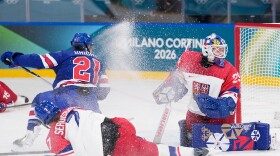 Czechia's Klara Seroiszkova slides into Czechia's Klara Peslarova, right, as United States' Hilary Knight scores her sides fourth goal during a preliminary round match of women's ice hockey between United States and Czechia at the 2026 Winter Olympics, in Milan, Italy, Thursday, Feb. 5, 2026.