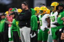 Oregon head coach Dan Lanning and players on the sidelines.