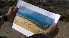 Jeff Moore, lead public affairs advisor for Chevron Environmental Management Company, displays a 2020 photo of the site. The area is now filled with native plants and wetlands.