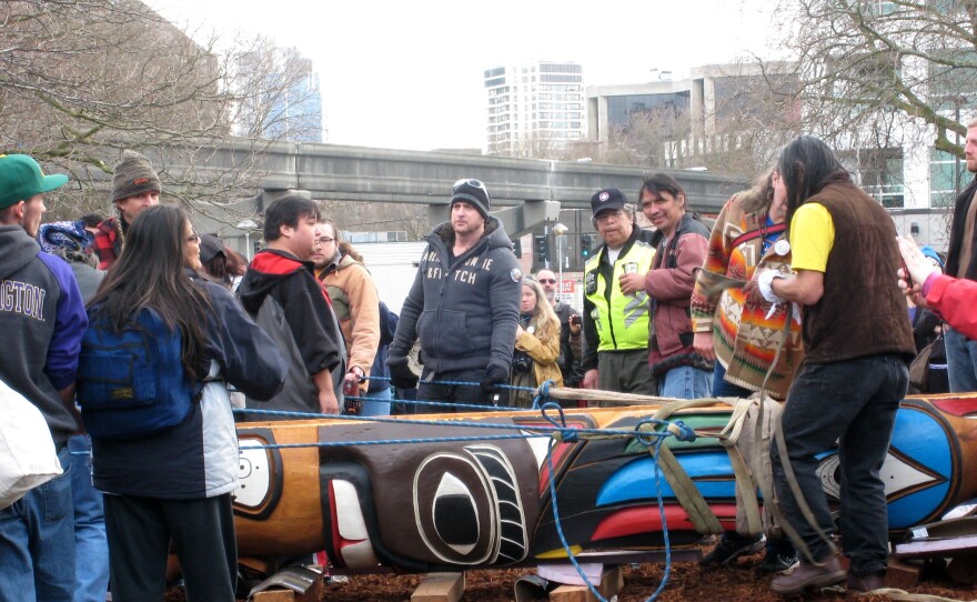 Roughly 90 people carried a totem honoring slain First Nations woodcarver John T. Williams from the Seattle Waterfront to Seattle Center on Sunday.