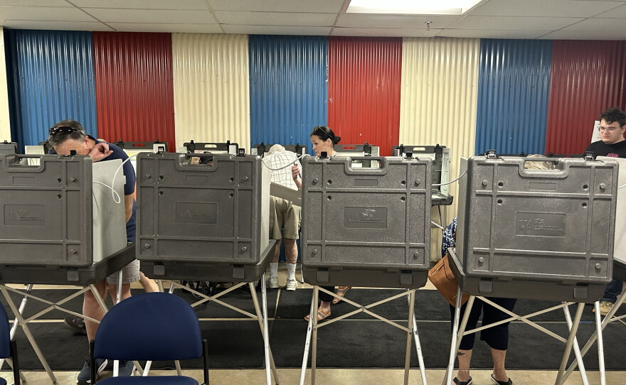 Voters cast their ballots at booths on Primary Election Day, Aug. 11, 2026, at the Chisholm Athletic Complex.