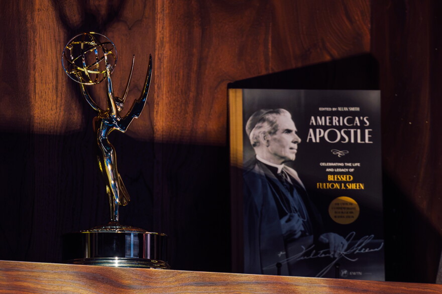 An Emmy Award won by the late Archbishop Fulton J. Sheen is displayed alongside a book about his life during his beatification Mass on Thursday at the Dome at America's Center in downtown St. Louis.