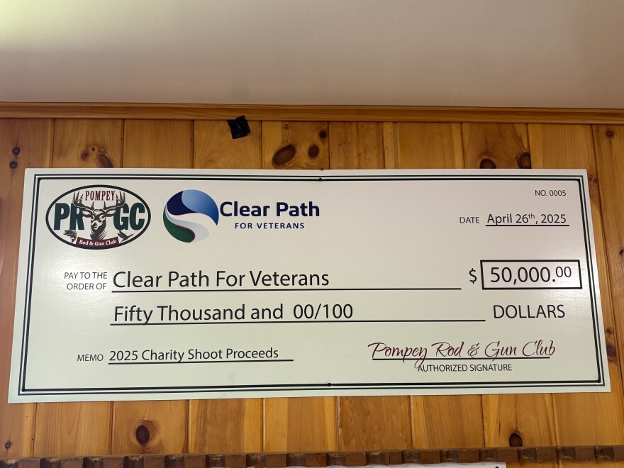 An oversized check for $50,000 made out to Clear Path for Veterans from the Pompey Rod and Gun Club