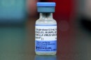 FILE - This Friday, May 17, 2019 file photo shows a vial of a measles, mumps and rubella vaccine in Mount Vernon, Ohio. On Thursday, Aug. 29, 2019, the first U.S. government report on mumps in migrant detention facilities say the virus has spread through 57 facilities in 19 states since September with new cases continuing as detainees are taken into custody or transferred. (AP Photo/Paul Vernon)