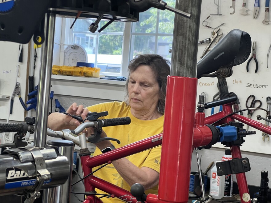 Founder Ginny Cress works on bike repairs at the Wheelhouse in Lima.