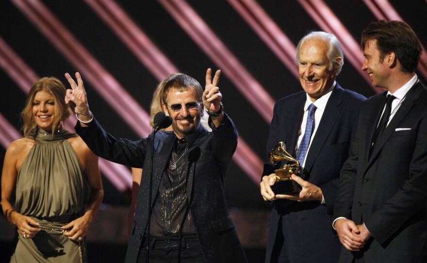 Ringo Starr celebrates as Martin holds the trophy for best compilation soundtrack album at the Grammy Awards in 2008.