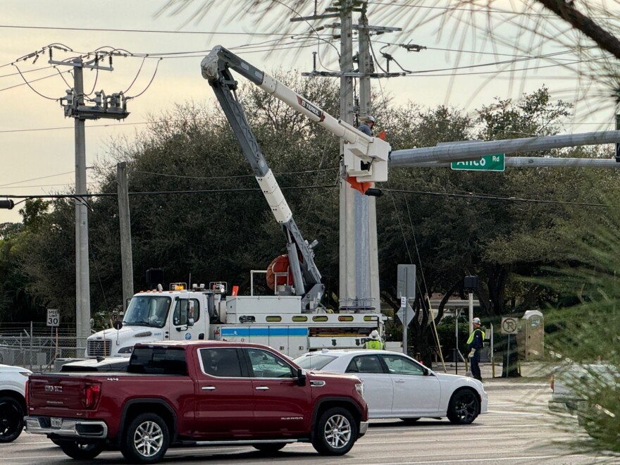 An FPL repair crew works on a connection at Alico and Oriole roads in south Lee County Sunday afternoon. Power outages affected traffic lights and up to 1,200 customers during the afternoon hours after high winds. arrived in the area.