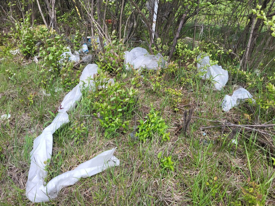 plastic trash is piled on the side of a highway in Ohio