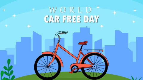 illustration of a bicycle on a green hill in front of a cityscape with the words WORLD CAR FREE DAY over the top 