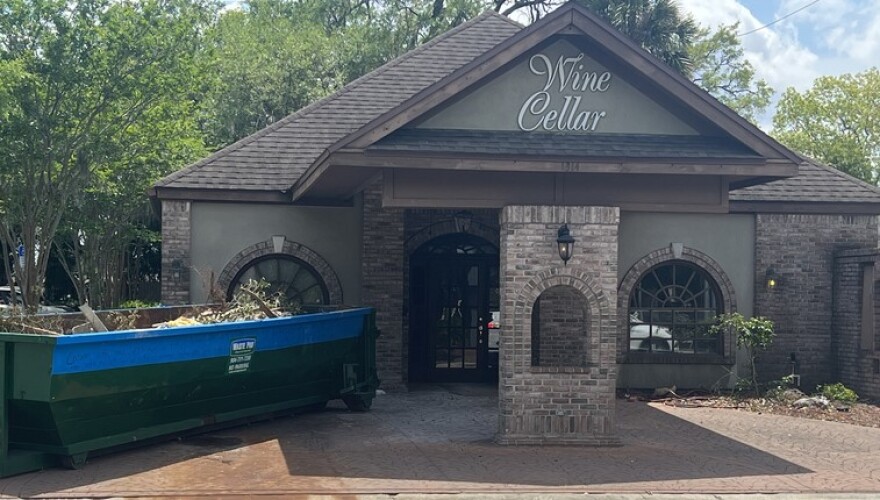 A dumpster sits outside the former Wine Cellar restaurant on Tuesday, April 5, 2022.