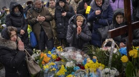 Nadia (center) prays at the grave of her son Oleg Kunynets, a Ukrainian military serviceman who was killed in the east of the country, during his funeral in Lviv, Ukraine, on Feb. 7.