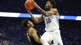 Kentucky's Keion Brooks Jr. (12) shoots over Missouri's Ronnie DeGray III (21) during the first half of an NCAA college basketball game in Lexington, Ky., Wednesday, Dec. 29, 2021. (AP Photo/James Crisp)