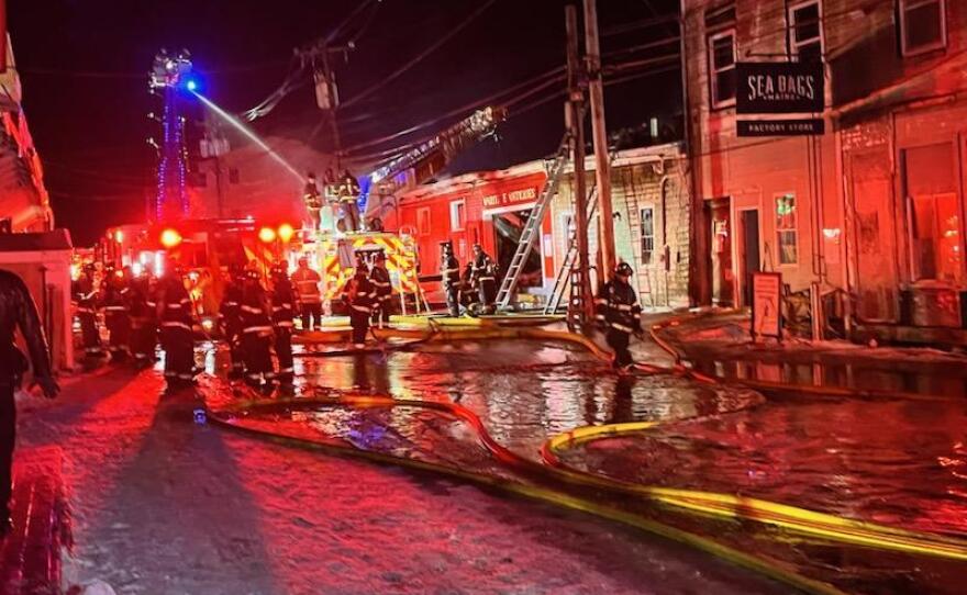Firefighters battle a three-alarm fire on Custom House Wharf in Portland on Friday, Dec. 26, 2025.