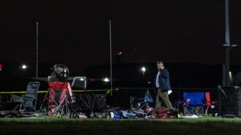 Investigators look over the scene at Stryker Sports Complex on Saturday after a truck drove onto the soccer field, killing two people.