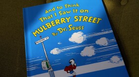 A copy of the book "And to Think That I Saw It on Mulberry Street," by Dr. Seuss, rests in a chair, Monday, March 1, 2021, in Walpole, Mass. (Steven Senne/AP)
