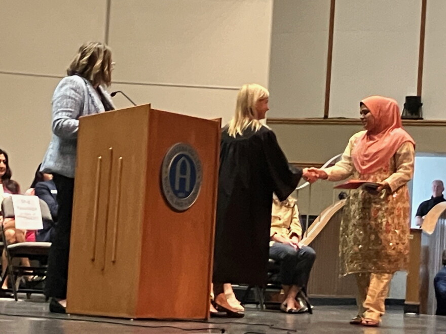 U.S. District Court Judge Sara Darrow (center) congratulates one of the new U.S. citizens Tuesday, Sept. 15 as Officer Andrea Walton of U.S. Citizenship and Immigration Services looks on.