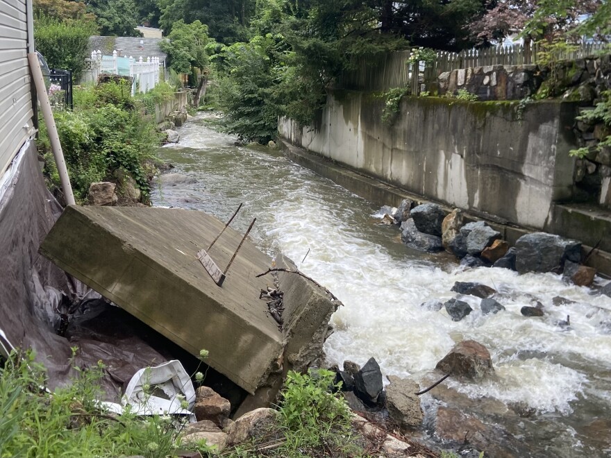 Pedestrians walk along Main Street in Highland Falls, NY on Monday, July 10, 2023 after it was was damaged by flooding the previous day.