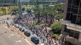 More than a thousand No Kings protesters gathered at City Hall in Orlando on Saturday.