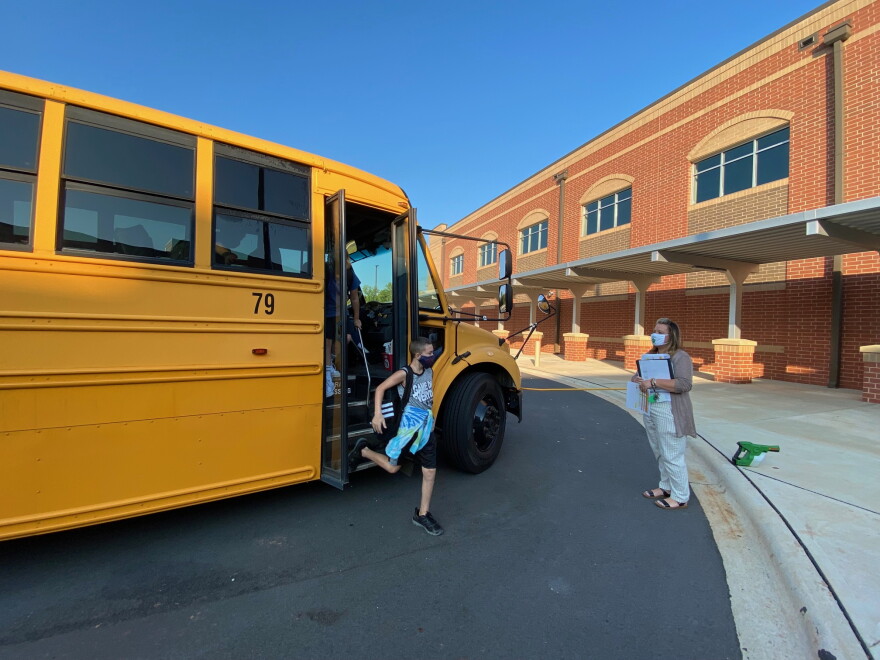 One of the first buses arrives at the new Belmont Middle School.
