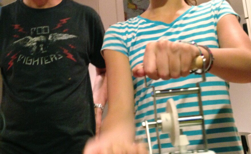 Riley Casagrande churns butter with her dad Jerry Casagrande.