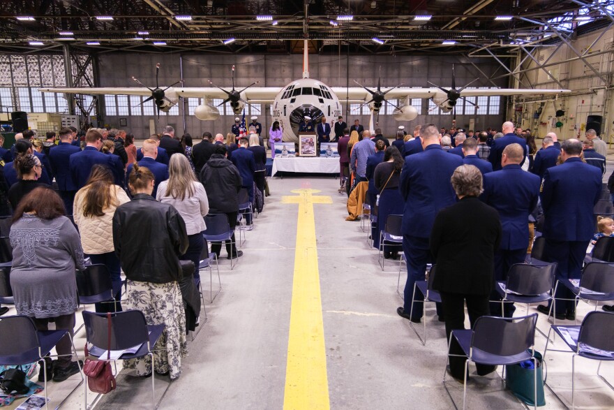 Attendees bow their heads during the convocation for the commissioning, held in an Air Station Kodiak hangar. The crew were joined by other Coast Guard officers and their families.