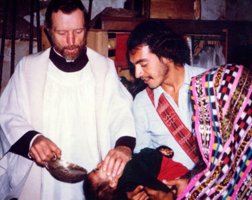 Father Stanley Rother baptizes a child in Guatemala.