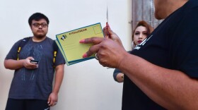 Volunteers with cards to be filled out and sent to members of the House of Representatives as Deferred Action for Childhood Arrivals (DACA) recipients wait in line at the Coalition for Humane Immigrant Rights office in Los Angeles on Sept. 30, 2017. Volunteer lawyers were on hand to offer assistance on the final weekend before the Oct. 5, 2017, deadline when more than 154,000 DACA recipients must renew their work permits before the program ends March 5, 2018. (Frederic J. Brown/AFP/Getty Images)