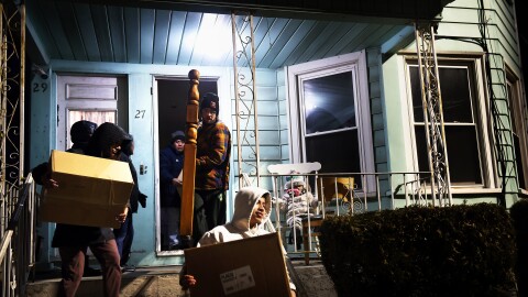 Members of Unidad Latina en Accion walk in and out of the home of Juana Valle and her family as they move from their 10-year-old apartment to another in New Haven, Connecticut on January 30, 2023 after being evicted.