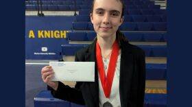Genevieve Laguna posing with her medal and award at the National History Day's state contest.