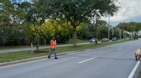 County road workers installing speed tubes and counters on Camino Real