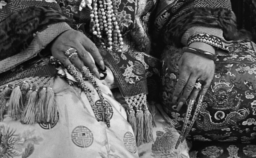 This close-up shows Cixi's gold filigreed fingernail covers, which were traditionally worn in the Qing court.