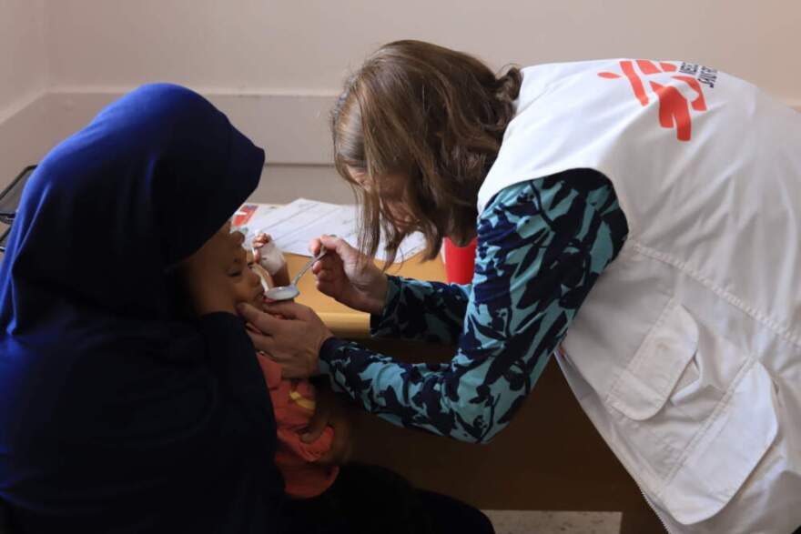 Dr. Joanne Perry checking on a child exhibiting signs of malnutrition in Nasser hospital, southern Gaza. (Courtesy of Doctors Without Borders)